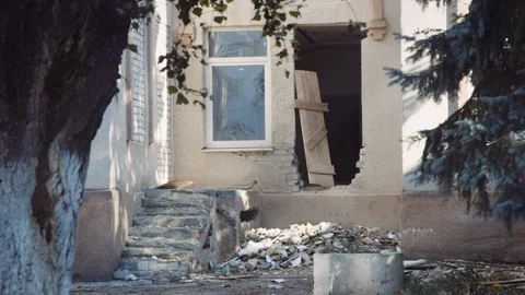 Abandoned broken down building seen from behind a chain link fence slow motion 스톡 동영상 122532591