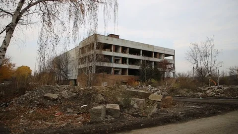 An abandoned building on a construction site and a departing dump truck Stock Footage 119192437