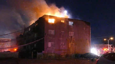 Abandoned building on fire in winter in dark devastation establishing scene Video stock 103455208