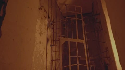 An abandoned building. the gate door or grate opens and closes by itself. the Stock Footage 238468404