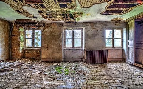 Abandoned Building Interior with Decayed Ceiling and Broken Windows Stock Photos