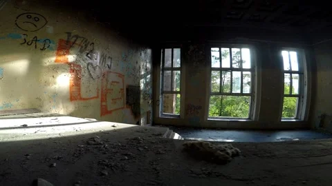 An abandoned building with large windows without glass, bright rays of sun Stock Footage 160909674
