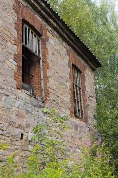 Abandoned building with no windows, with bars on the windows Stock Photos