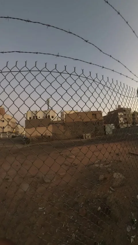 Abandoned Buildings Behind a Barbed Wire Fence Stock Footage 346534419