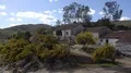 Abandoned buildings with blooming bushes and dry hills landscape at Mértola Prt 4k or 4k+ Resolution