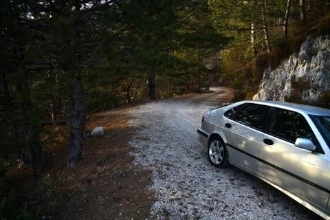 Abandoned car on forest path Stock Photos