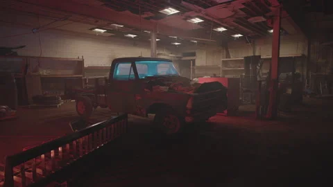 Abandoned car garage with broken down vehicles in dim lighting Stock Footage 320047036