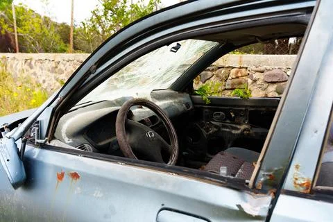 Abandoned Car Interior with Smashed Windshield and Rusted Bodywork Stock Photos