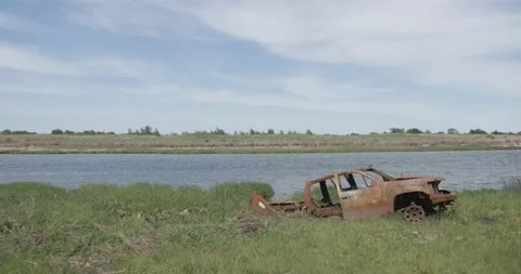 Abandoned car by lake Stock Footage 239582982