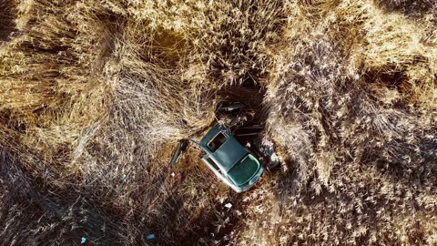 An abandoned car in the middle of a field Stock-Footage 141998302