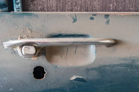 Abandoned car with missing lock part. Stock Photos