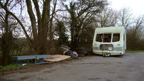 Abandoned caravan deteriorating along roadside creating unsafe living Stock Footage 328359098