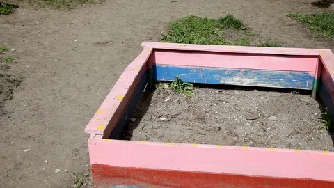 Abandoned children's sandbox without the sand, no body Stock Footage 125280332