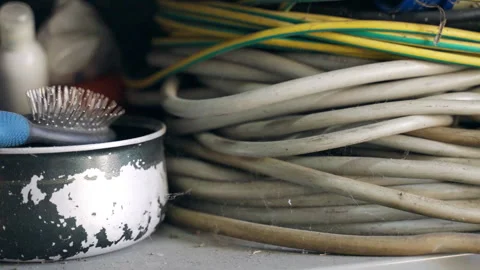 Abandoned coil wires of different sizes and dirty rusty crockery in warehouse Stock Footage 316688531