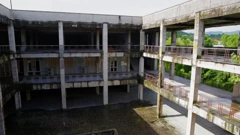 Abandoned concrete building complex with deteriorated structure, nature 스톡 동영상 347567189