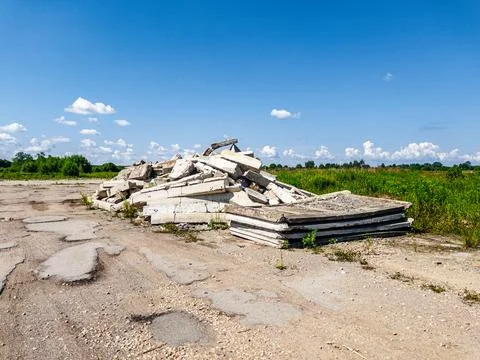 An Abandoned Construction Site Characterized by Piled Debris and Surrounding Stock Photos