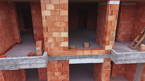 Abandoned construction site. Derelict brick edifice featuring open spaces and Stock Footage 337948669