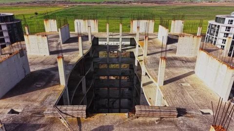 Abandoned construction site with exposed concrete and rebar at sunset Stock Footage 325085222