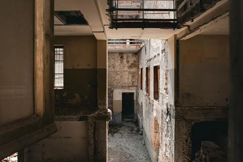 Abandoned, damaged interior building with falling apart brick walls and debris Stock Photos