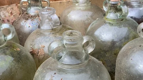 Abandoned demijohn bottles used for making moonshine 스톡 동영상 111253604