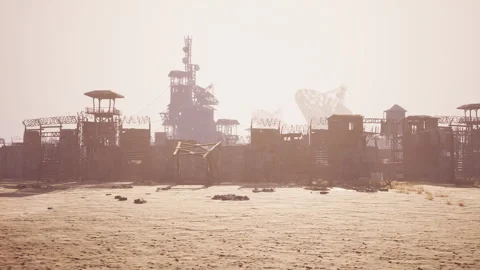 Abandoned desert outpost with weathered structures and distant towers Stock Footage 330069434