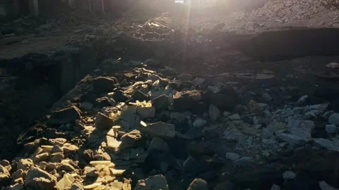 Abandoned destroyed factory. The sun's rays shine through the holes in the walls Stock Footage 261761241