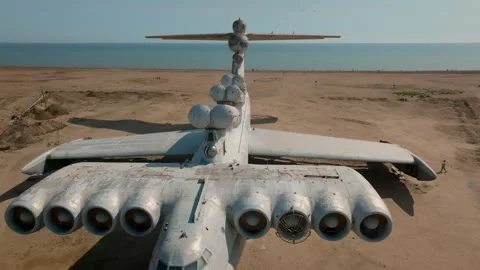Abandoned ekranoplan ground effect aircraft on sandy shore, aerial view footage Stock Footage 334102346