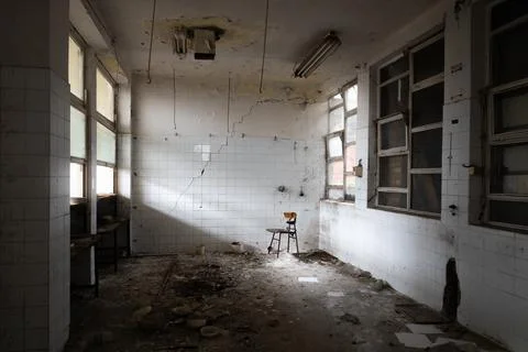 Abandoned empty kitchen with chair in corner Stock Photos