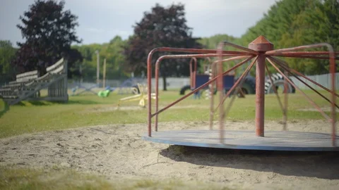 Abandoned Empty Old Merry Go Round Spinning at Children's Playground Flat Video stock 100630005