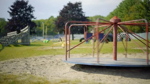 Abandoned Empty Old Merry Go Round Spinning at Children's Playground Stock Footage 100630150