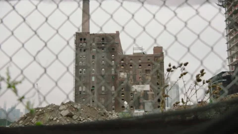Abandoned factory viewed through fence in Brooklyn, New York Stock Footage