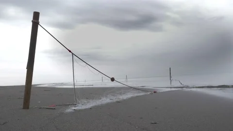 Abandoned fishnet at the empty beach. Stock Footage 138443177