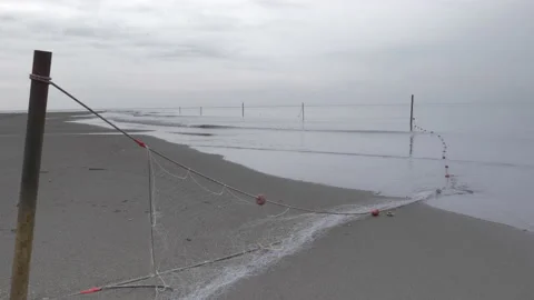 Abandoned fishnet at the empty beach. Stock Footage 138448568