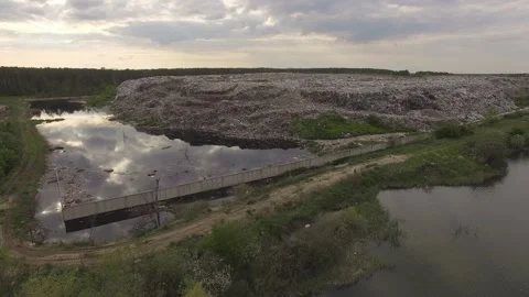 Abandoned flooded garbage city dump. Garbage on the banks of the river Stock Footage 157054817