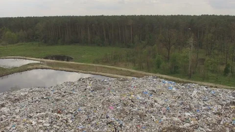 Abandoned flooded garbage city dump. Garbage on the banks of the river Stock Footage 167470455