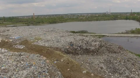 Abandoned flooded garbage city dump. Garbage on the banks of the river Stock Footage 167470568