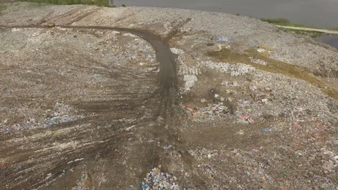 Abandoned flooded garbage city dump. Garbage on the banks of the river Stock Footage 168495534