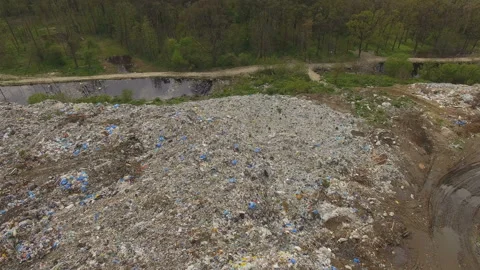 Abandoned flooded garbage city dump. Garbage on the banks of the river Stock Footage 168495674