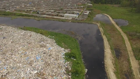 Abandoned flooded garbage city dump. Garbage on the banks of the river Stock Footage 168495700