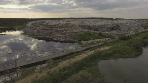Abandoned flooded garbage city dump. Garbage on the banks of the river Stock Footage 168495778