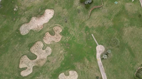 Abandoned golf course downward topdown aerial birdseye view overgrown grass Stock Footage 276192330