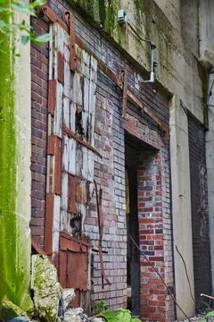 Abandoned Grain Elevator Doorway with Rust and Moss, Urban Decay 스톡 사진