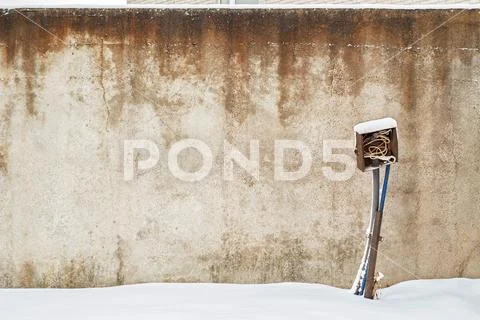 Abandoned grunge house with electrical equipment near the wall in winter. Stock Photos