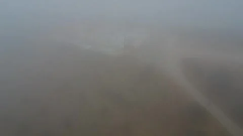 Abandoned hilltop graveyard in dense mist near traditional rural church Stock Footage 344094517