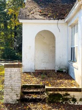 Abandoned Historic Structure With Arched Entry and Weathered Stucco Stock Photos