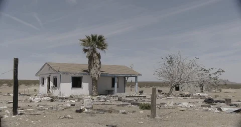 Abandoned House with Junk in Front Yard in Desert Stock Footage 89943076