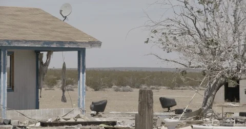 Abandoned House with Junk in Front Yard in Desert - Detail Stock Footage 89943102