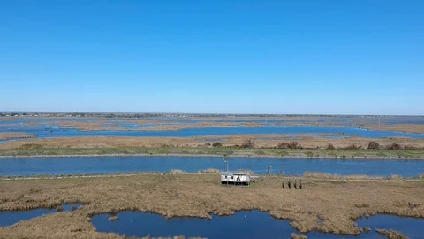 An abandoned house sitting on stilts deep in the Louisiana bayou on a clear day Stock Footage 101552250