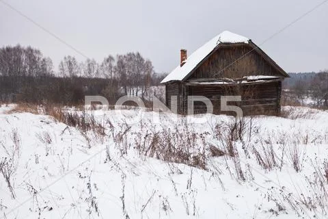 Abandoned house in snow-covered village Stock Photos