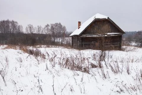 Abandoned house in snow-covered village Stock Photos